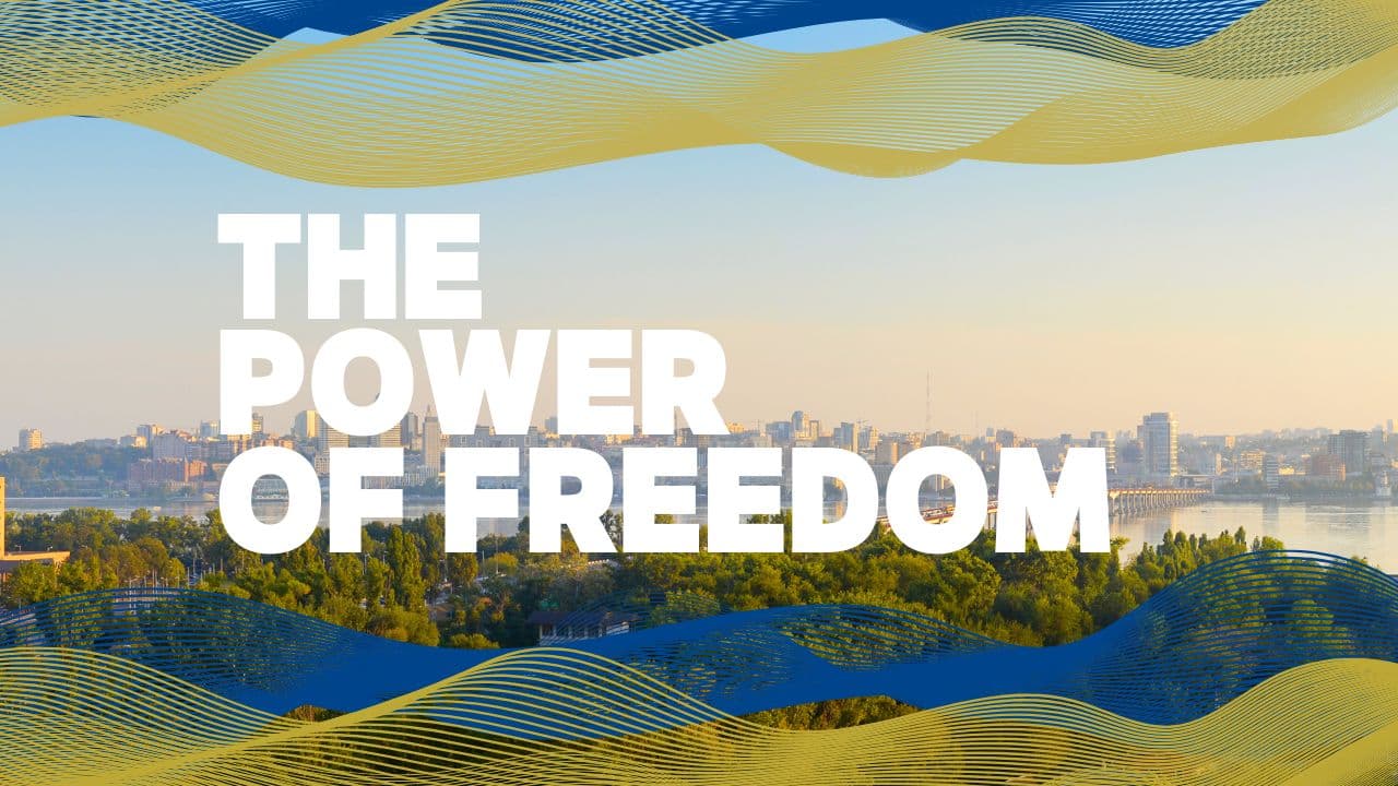 Text The power of freedom on the background of a panoramic photo of the Dnipro city